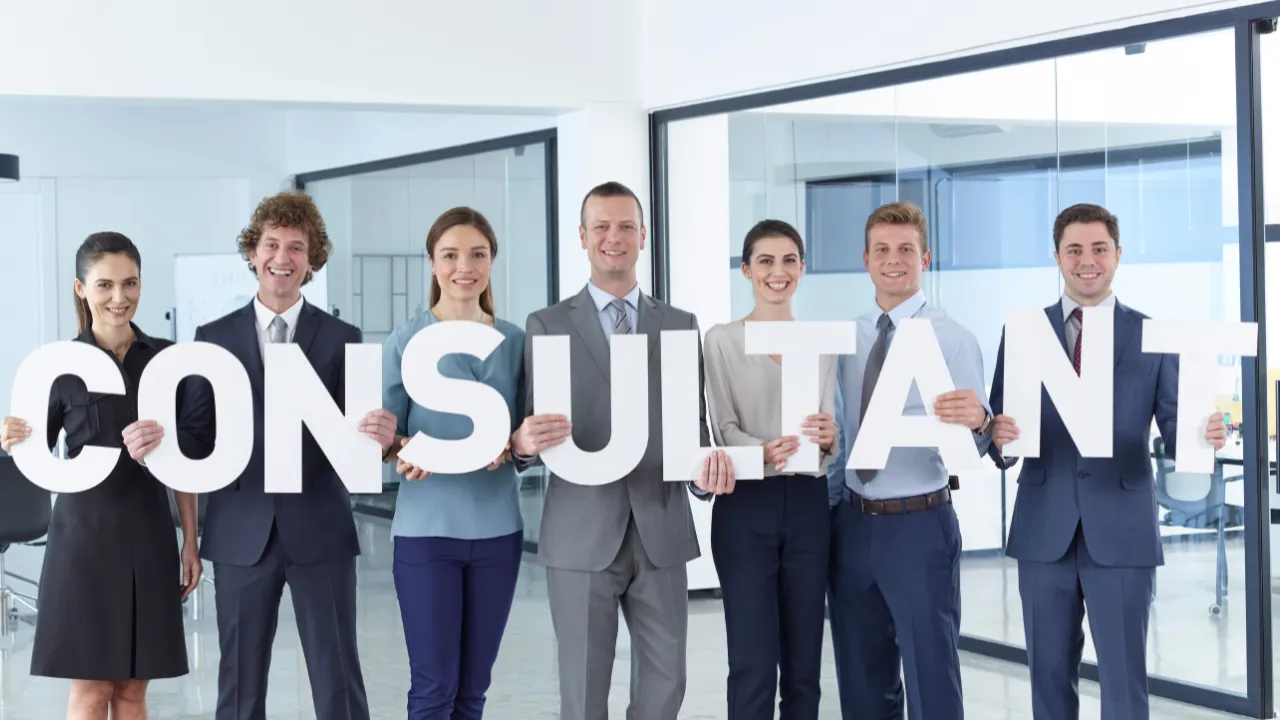 consultant sign being held by group of professionals