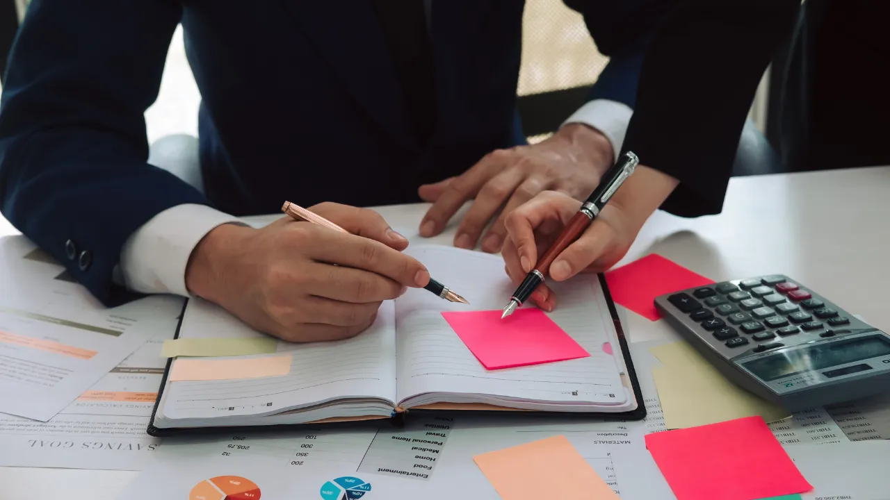 Two professionals consulting their agenda