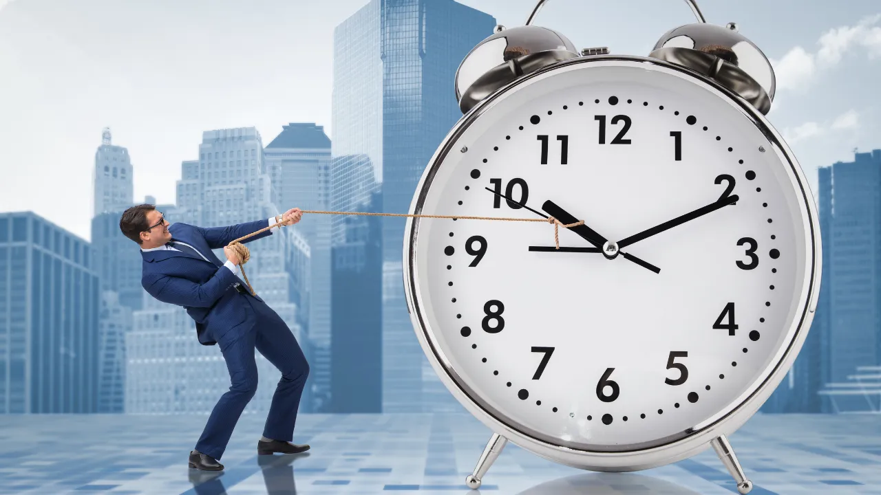 A corporate man pulling a giant clock