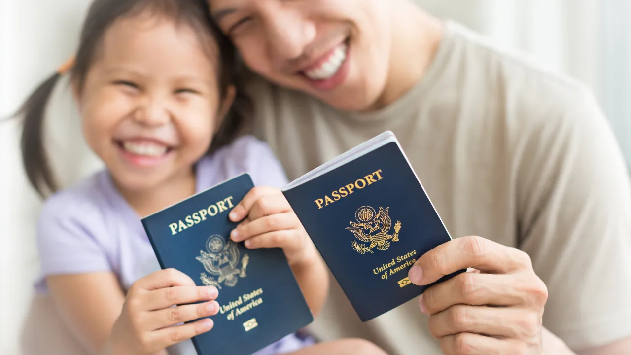 A father and child holding their US passports
