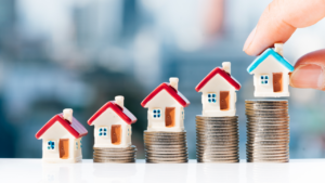 A collection of houses on top of investment in the form of change.