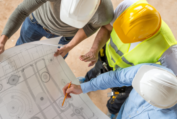 3 engineers working together looking at a chart | Scott Legal, P.C. 3 engineers working together looking at a chart
