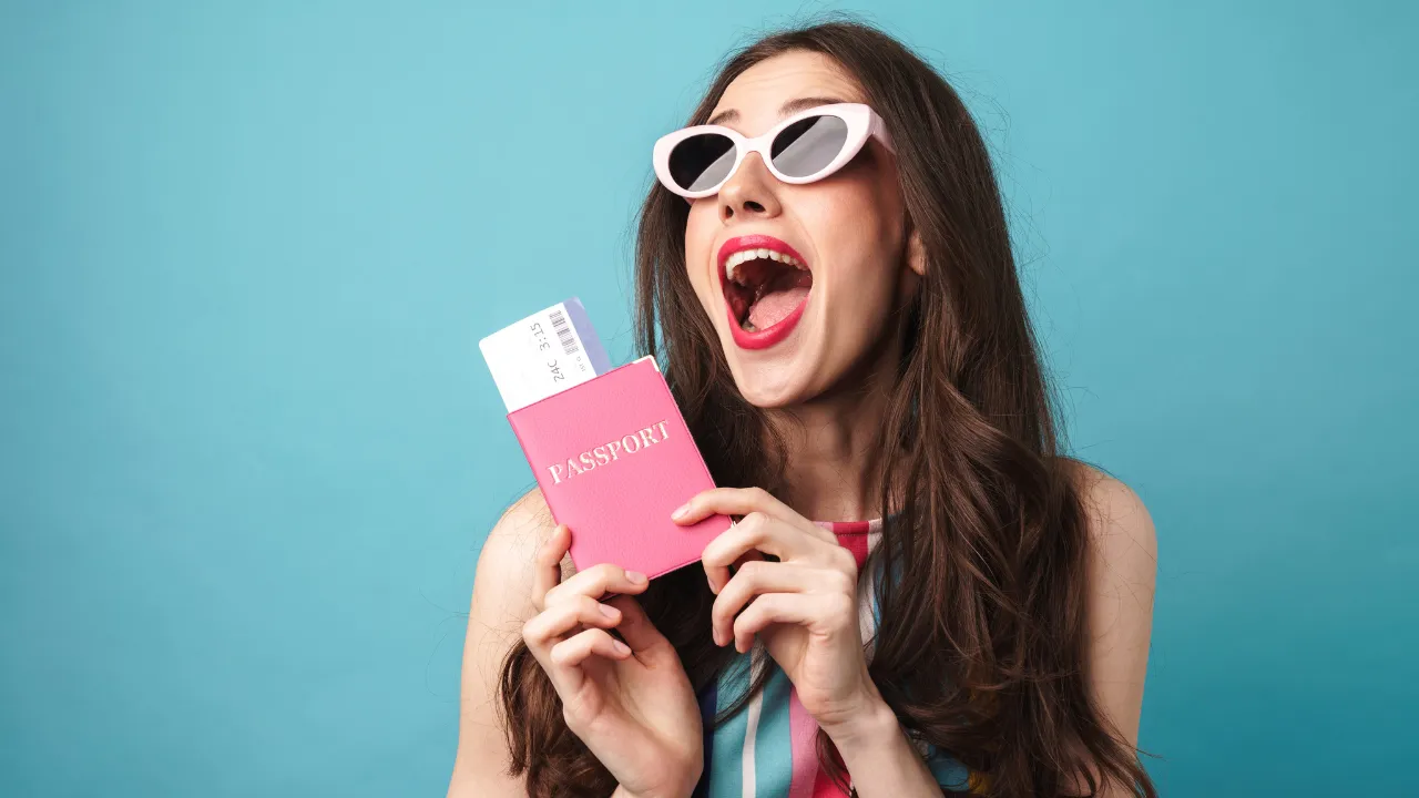 A woman holding a passport in excitement
