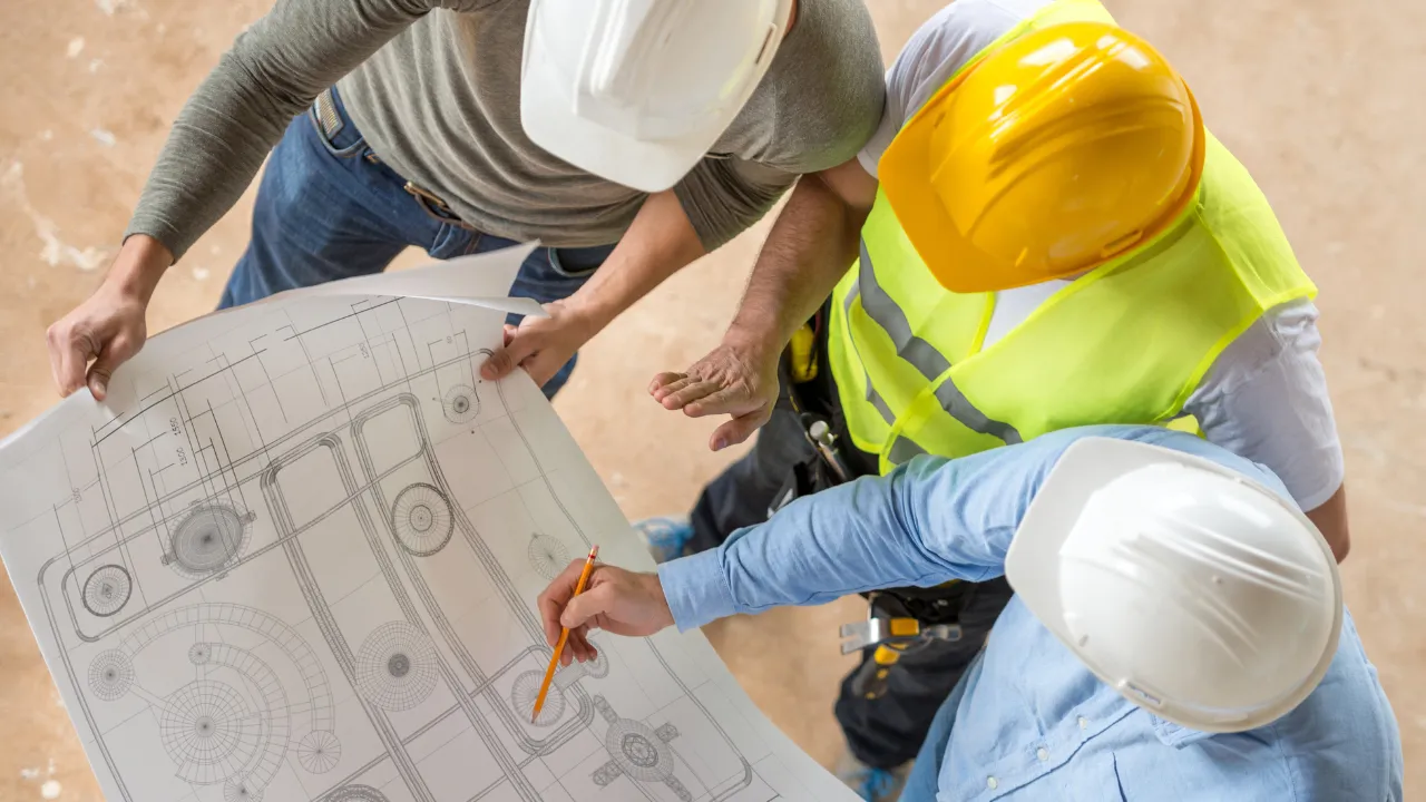 3 engineers working together looking at a chart