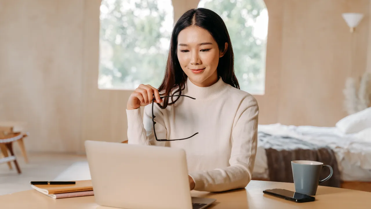 A woman conducting business on a laptop