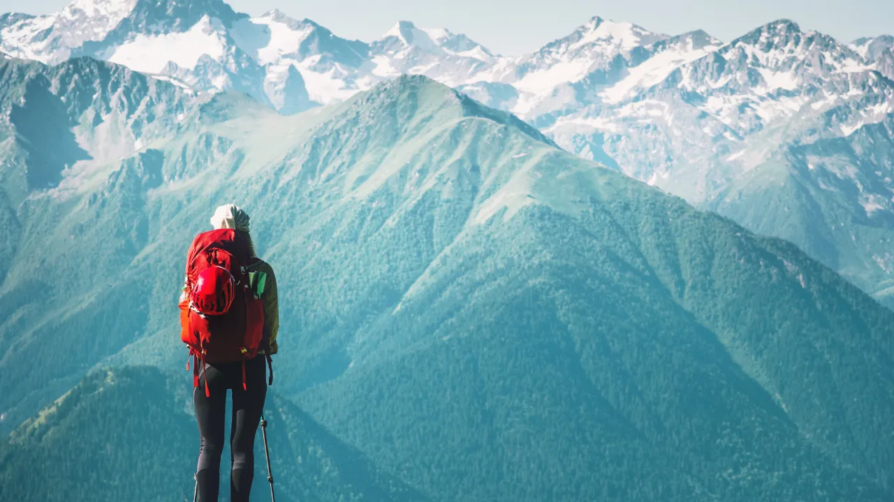 A traveler looking at the mountains ahead of her