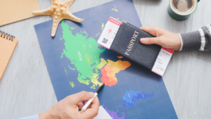 Man holding passport in hand while consulting a map
