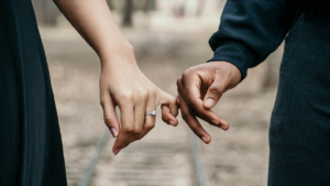 Married couple linking hands