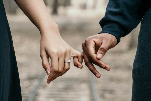 Married couple linking hands