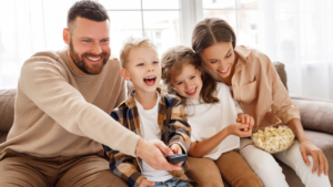 Happy family watching a movie on the couch