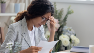 A woman reading a denial notice