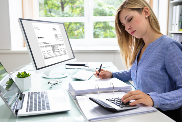 An accountant working on an invoice | Scott Legal, P.C. An accountant working on an invoice