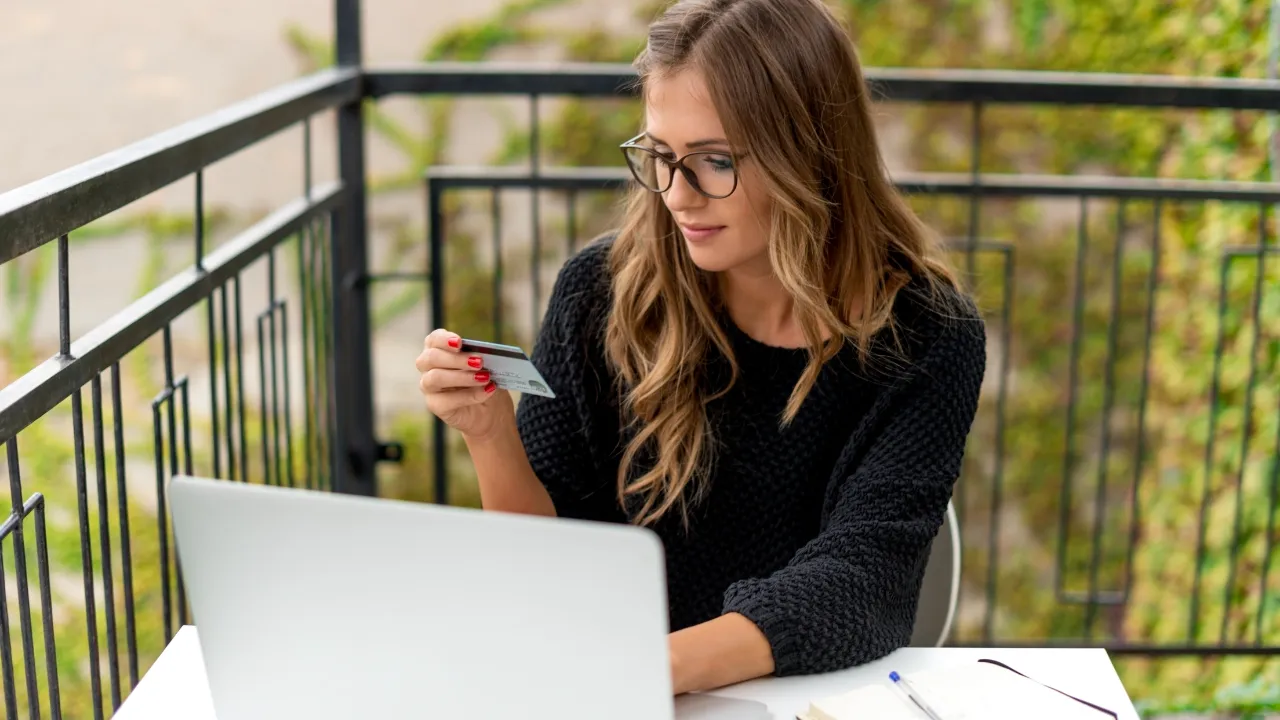 A woman consulting her credit card