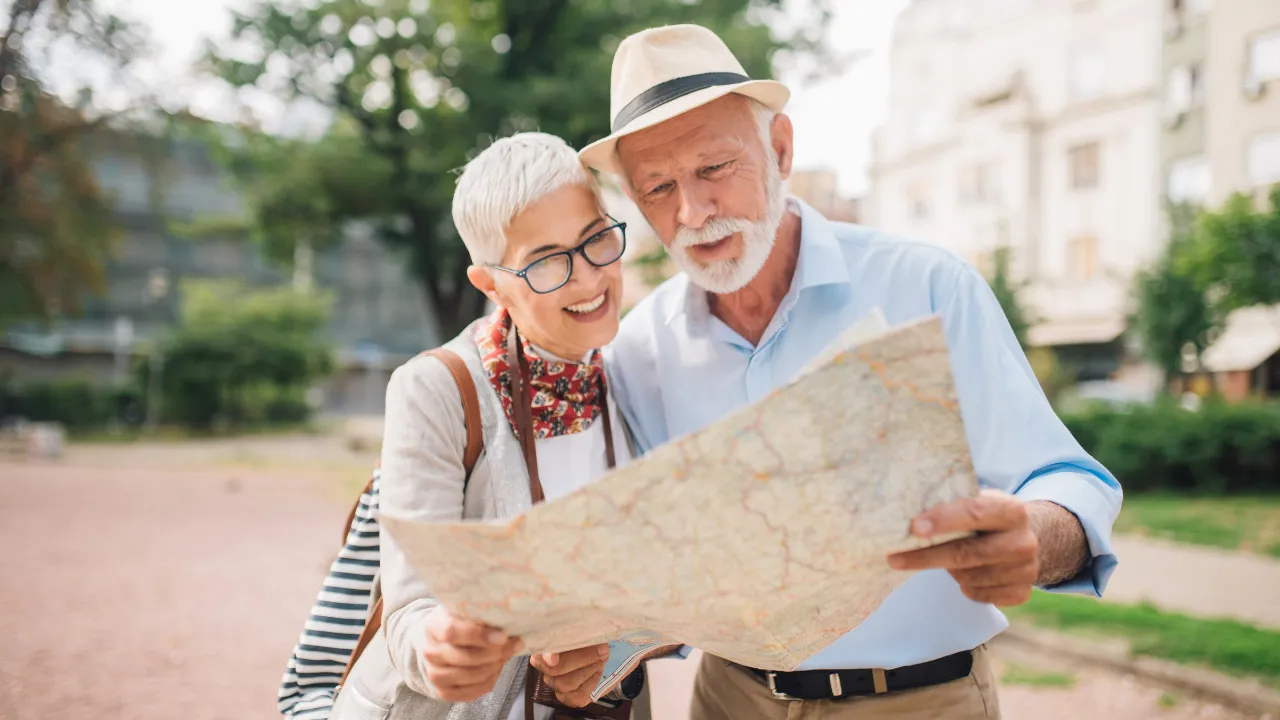 Two tourists looking at a map while travelling