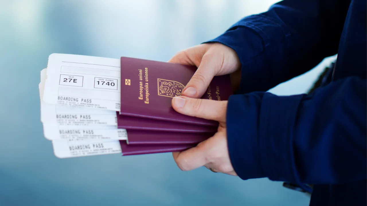 An individual holding a bunch of European passports and boarding passes