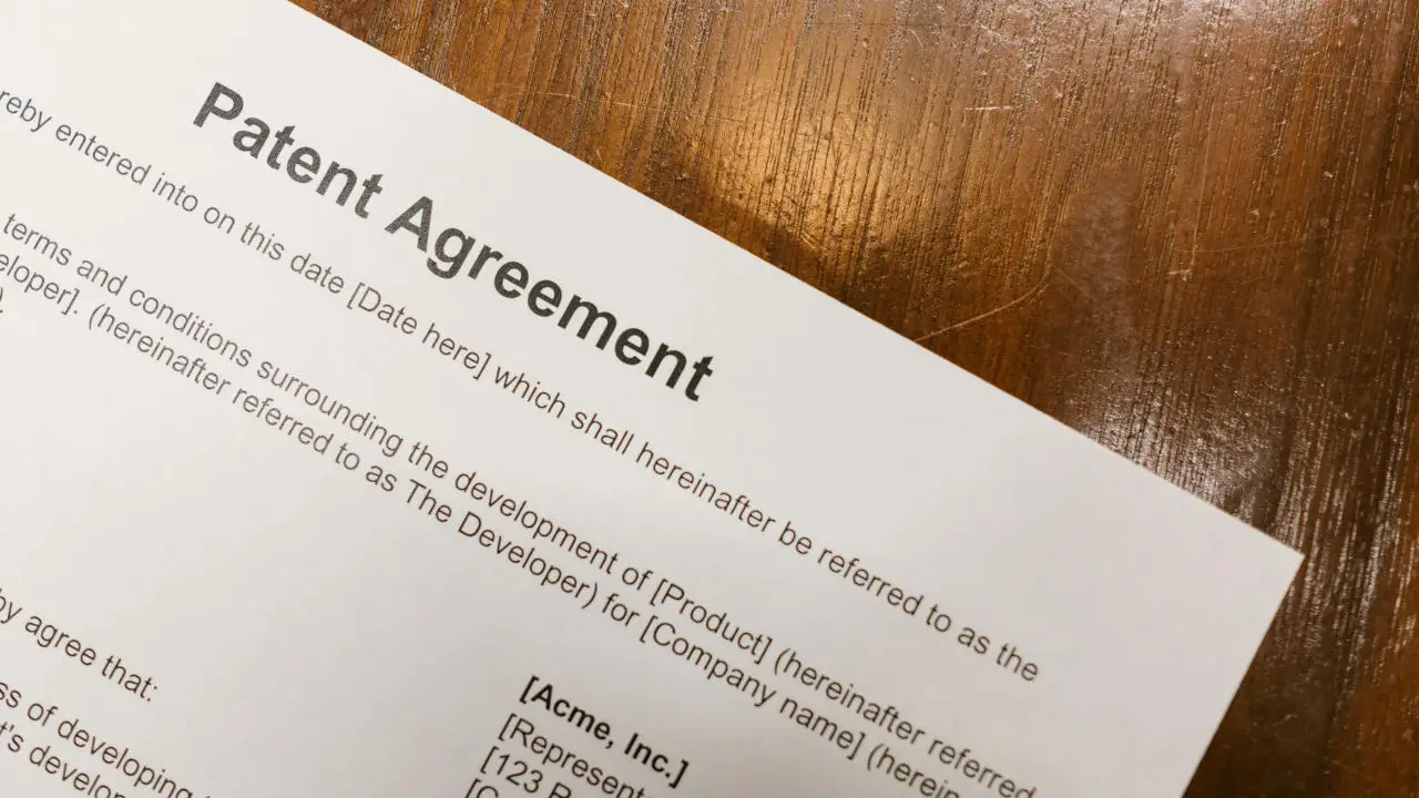 A patent agreement document on a table.