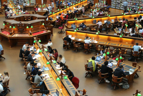 F-1 Student Visa | Scott Legal, P.C. A library full of students, some possibly on an F-1 Visa.