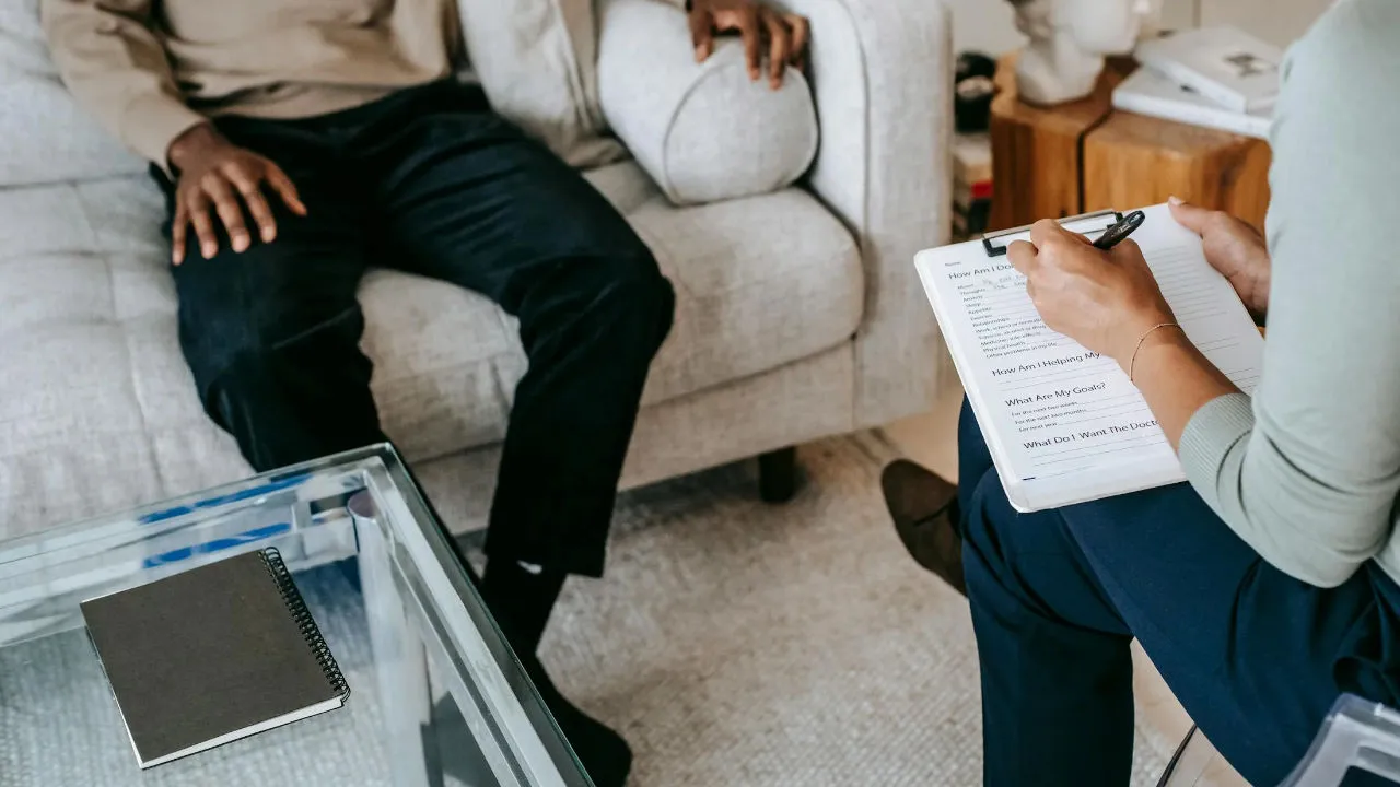 Therapy session between psychologist and patient.