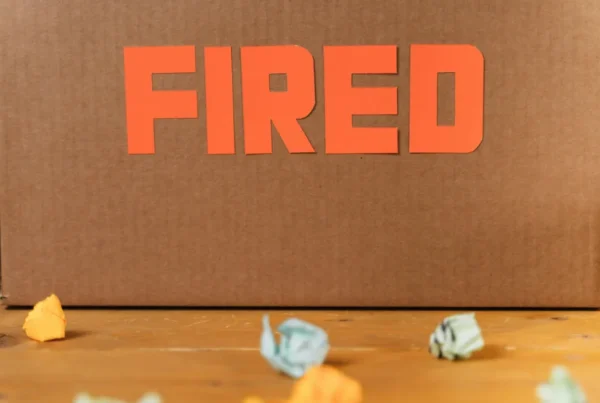 Cardboard box with “FIRED” sign symbolizing employee layoffs affecting PERM labor certification