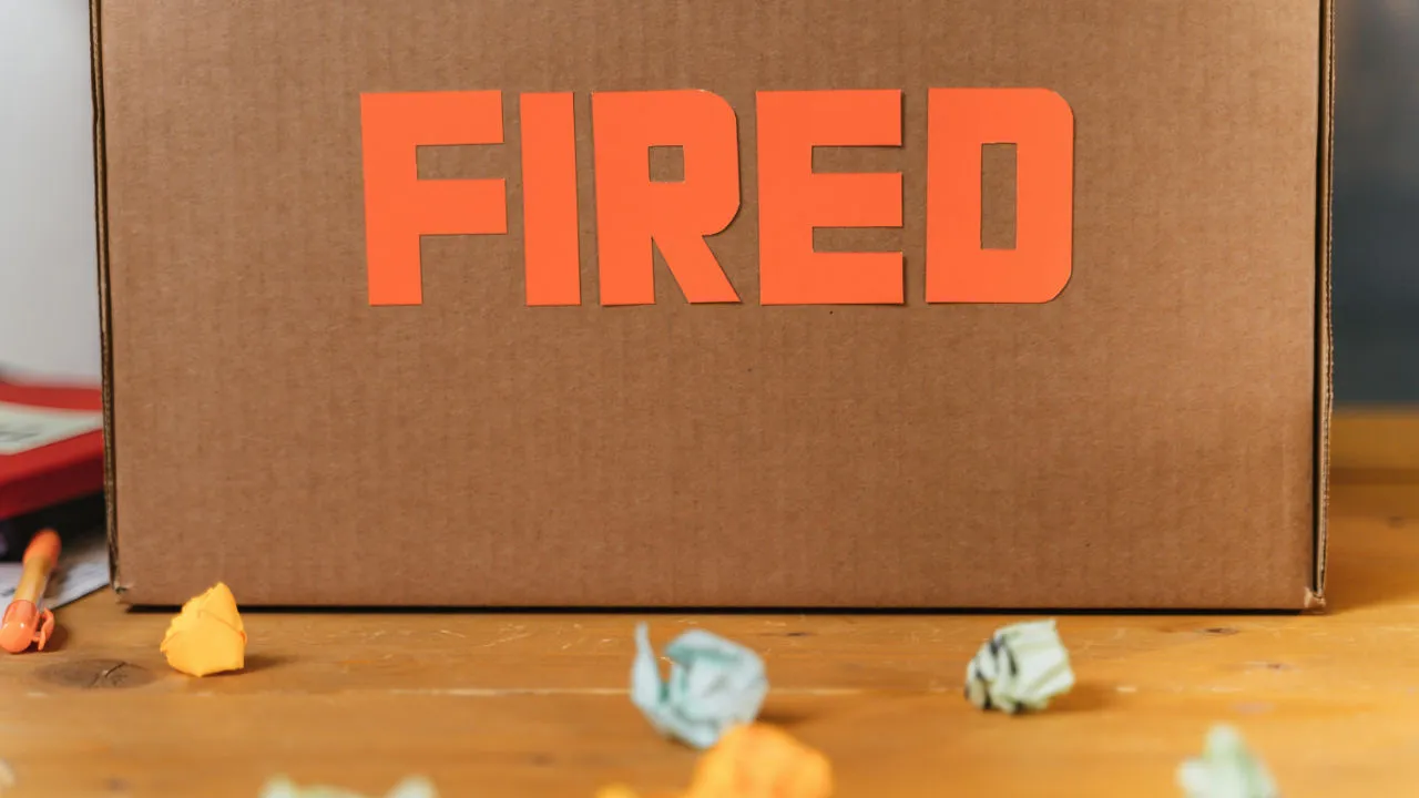 Cardboard box with “FIRED” sign symbolizing employee layoffs affecting PERM labor certification