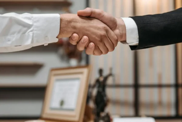 A firm handshake between a U.S. employer and a professional, finalizing a cost-effective hiring agreement with a TN visa.