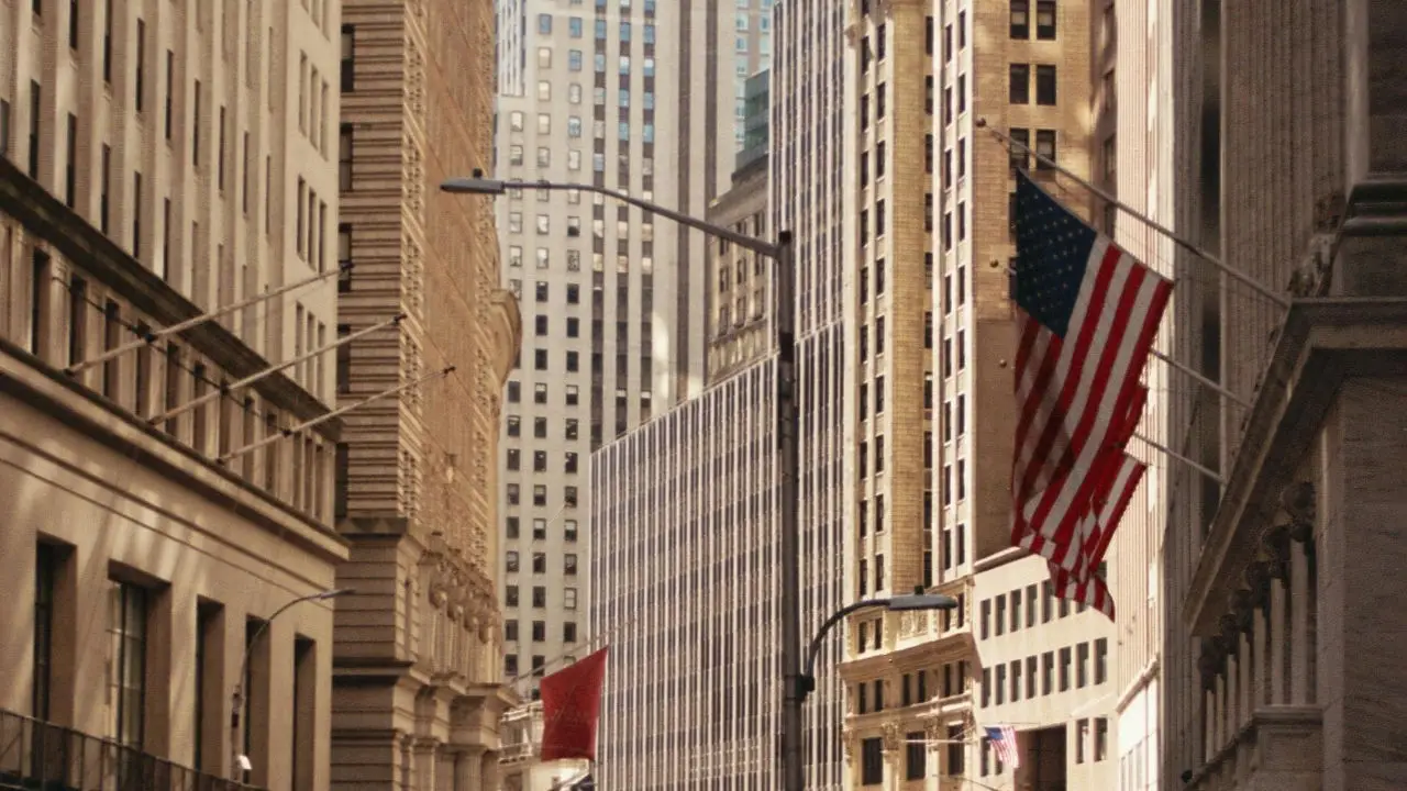 American flag hanging from a building on a city street in the United States