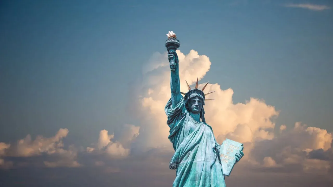 The Statue of Liberty against a cloudy sky, symbolizing the opportunity of U.S. immigration through the EB-2 NIW.