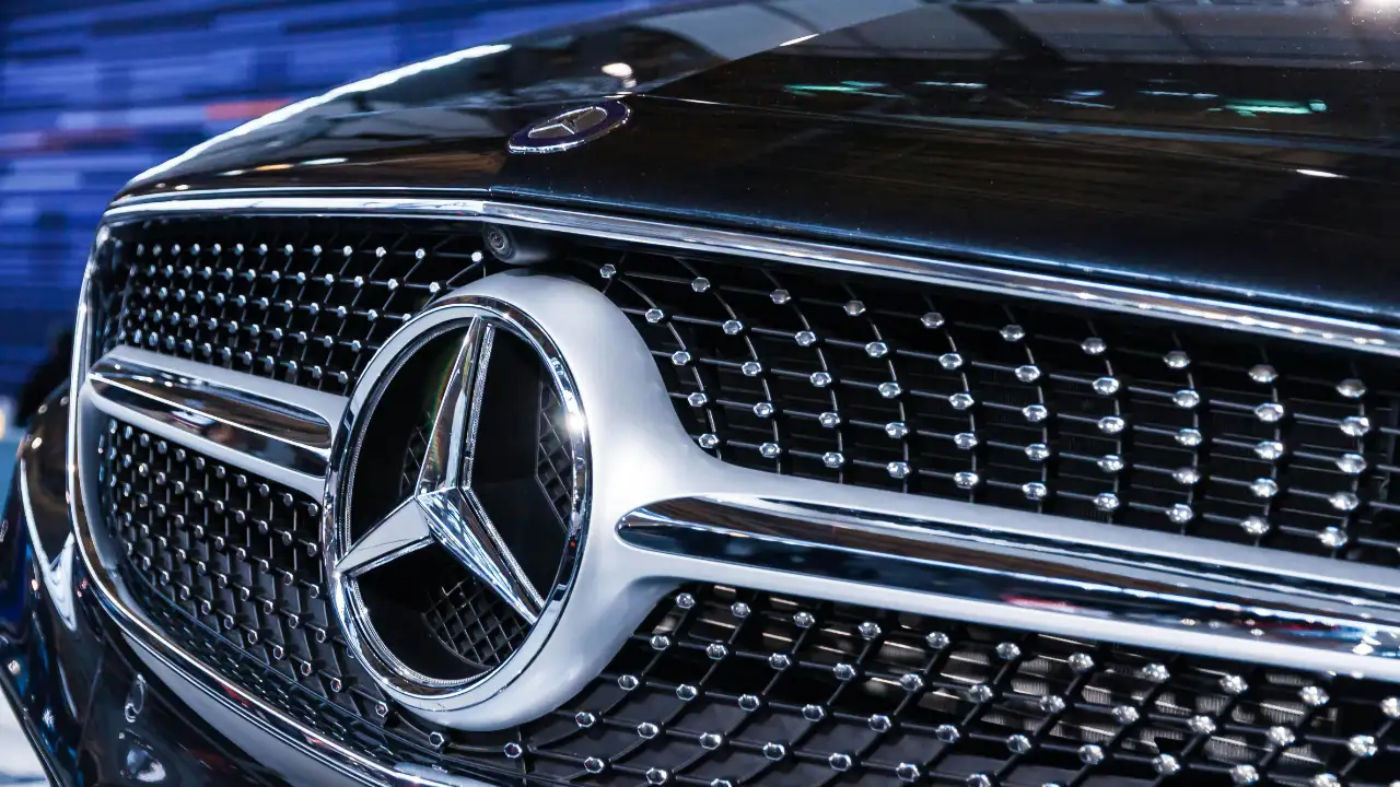 The front grill of a luxury car, representing the question of whether a vehicle is a valid E-2 visa expenditure.