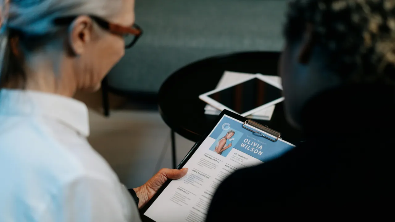 A professional looking at a resume, symbolizing the question of work authorization after an NIW approval.