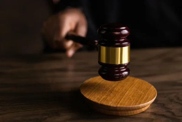 A judge's gavel hitting a sounding block, representing the legal action of suing for immigration delays.