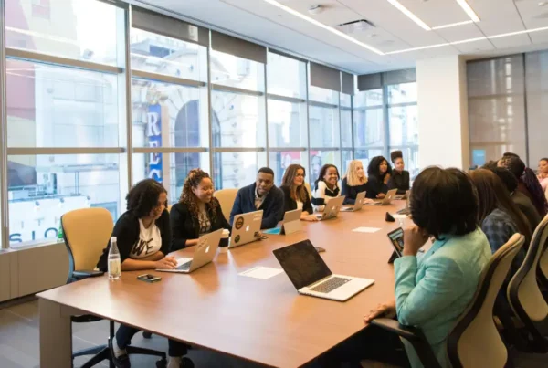 Professional woman working on a laptop in a modern office setting representing H-1B visa professionals.