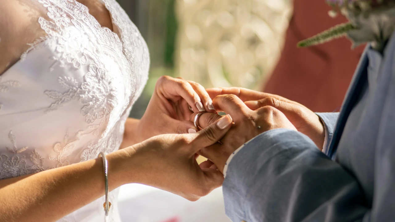 Close-up of two people exchanging wedding rings during a marriage ceremony.