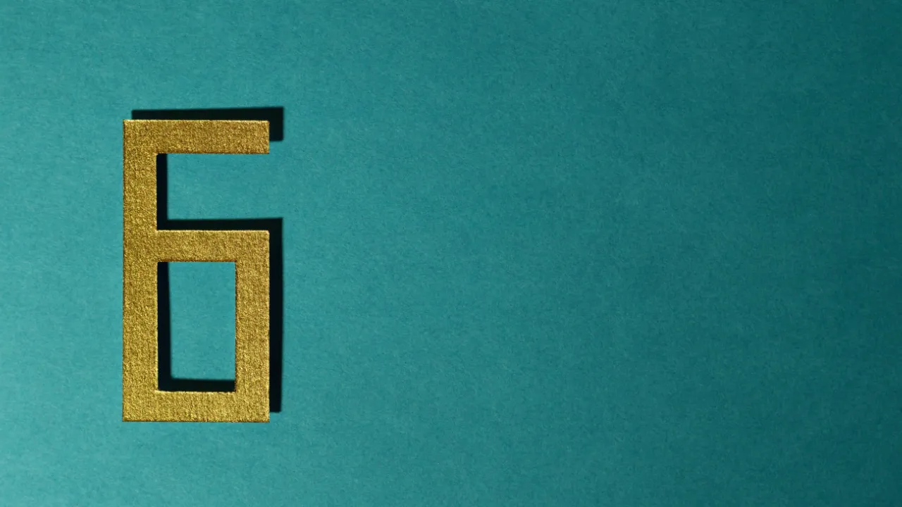 Metallic gold number 6 on a teal background representing the H-1B six-year limit and legal options to extend H-1B beyond 6 years.