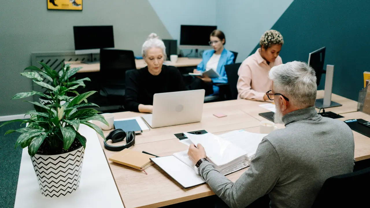 Diverse small business team meeting in a modern office to discuss L-1 visa and immigration strategy