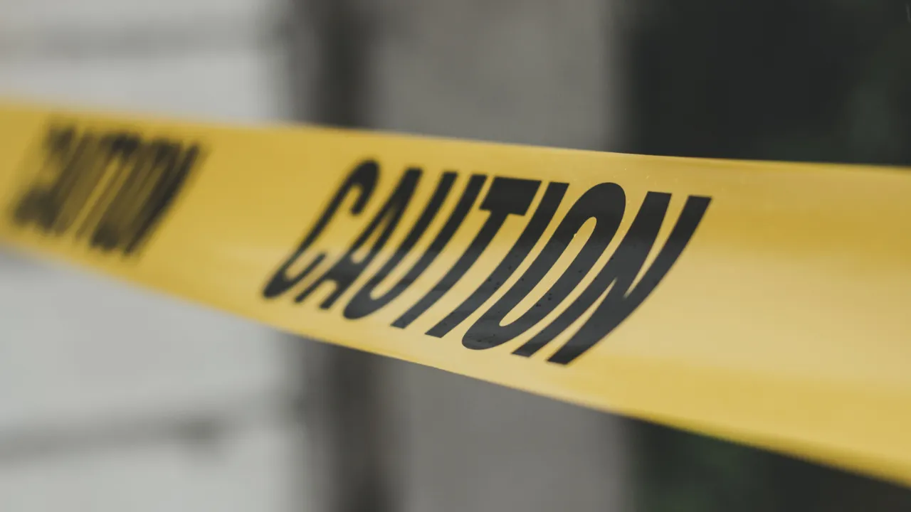 Yellow caution tape stretched across a doorway, representing the risk of nonimmigrant status violations