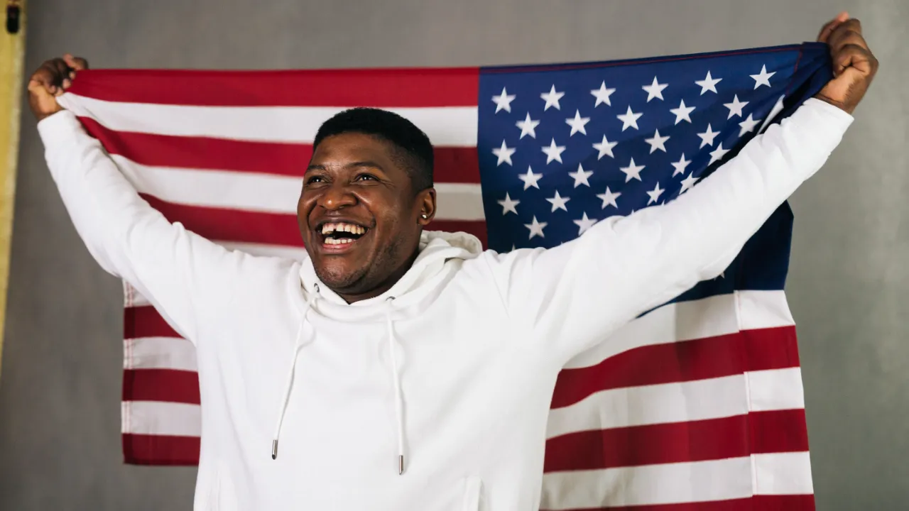New U.S. citizen holding an American flag after completing naturalization