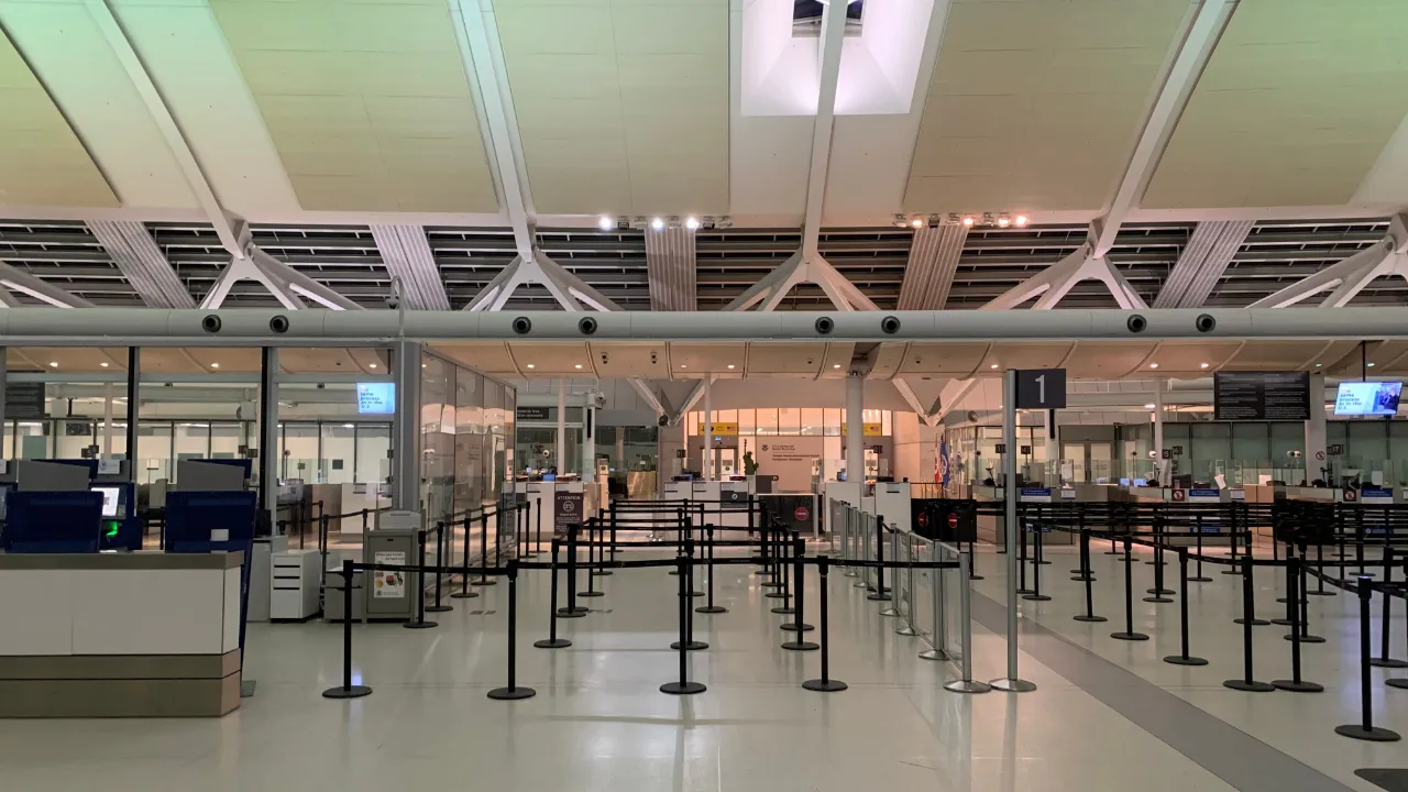 Empty stanchion queue lines in an airport immigration inspection hall